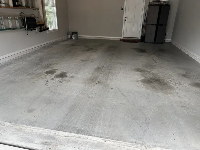Stained concrete garage floor before garage floor coating installation in Charleston, SC